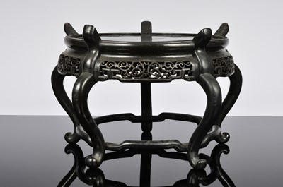 Lot 516 - A Chinese carved hardwood stand