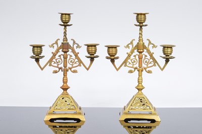 Lot 575 - A pair of late Victorian brass candelabra