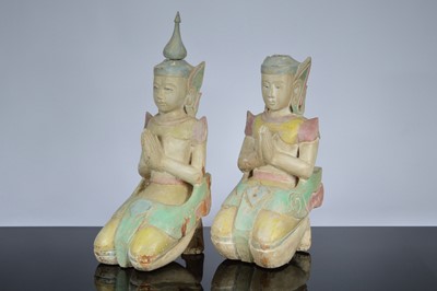 Lot 605 - A pair of carved wooden and gesso painted praying figures