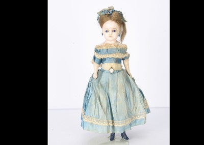 Lot 1191 - A German mid 19th century dipped wax over composition shoulder head child doll