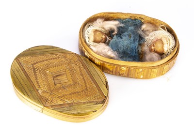 Lot 1207 - A 19th century straw work oval box with wax headed marriage couple