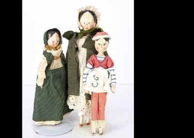 Lot 1211 - Three German pegged wooden dolls