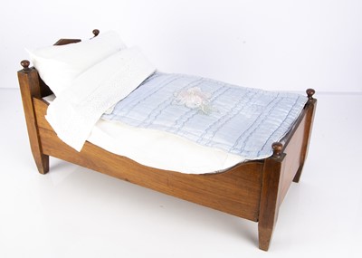 Lot 1217 - An early 20th century wooden doll’s bed