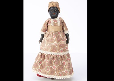 Lot 1240 - A carton headed black doll