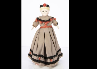 Lot 1252 - A mid 19th century German wax over composition Pumpkin head doll with moulded bonnet