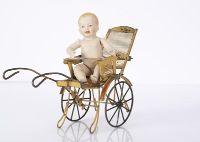 Lot 1388 - An early 20th century doll’s tinplate pushchair