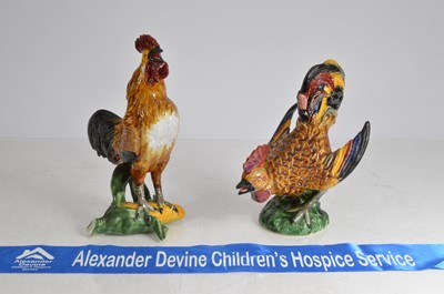 Lot 31 - A pair of pottery cockerels