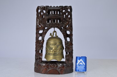 Lot 42 - Oriental brass bell and carved wooden stand