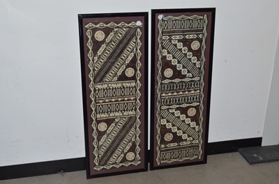 Lot 106 - A pair of framed vintage tribal decorations on printed paper