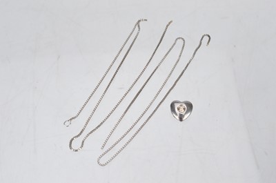 Lot 152 - A small modern white 9ct gold and diamond heart shaped pendant