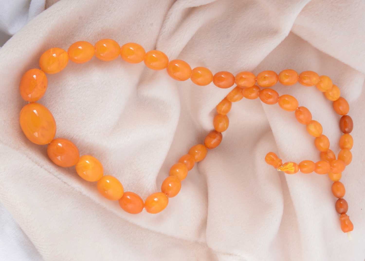 Lot 5 - A butterscotch amber string of oval graduated beads