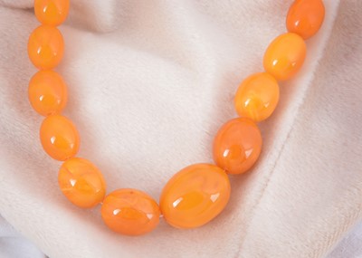 Lot 5 - A butterscotch amber string of oval graduated beads