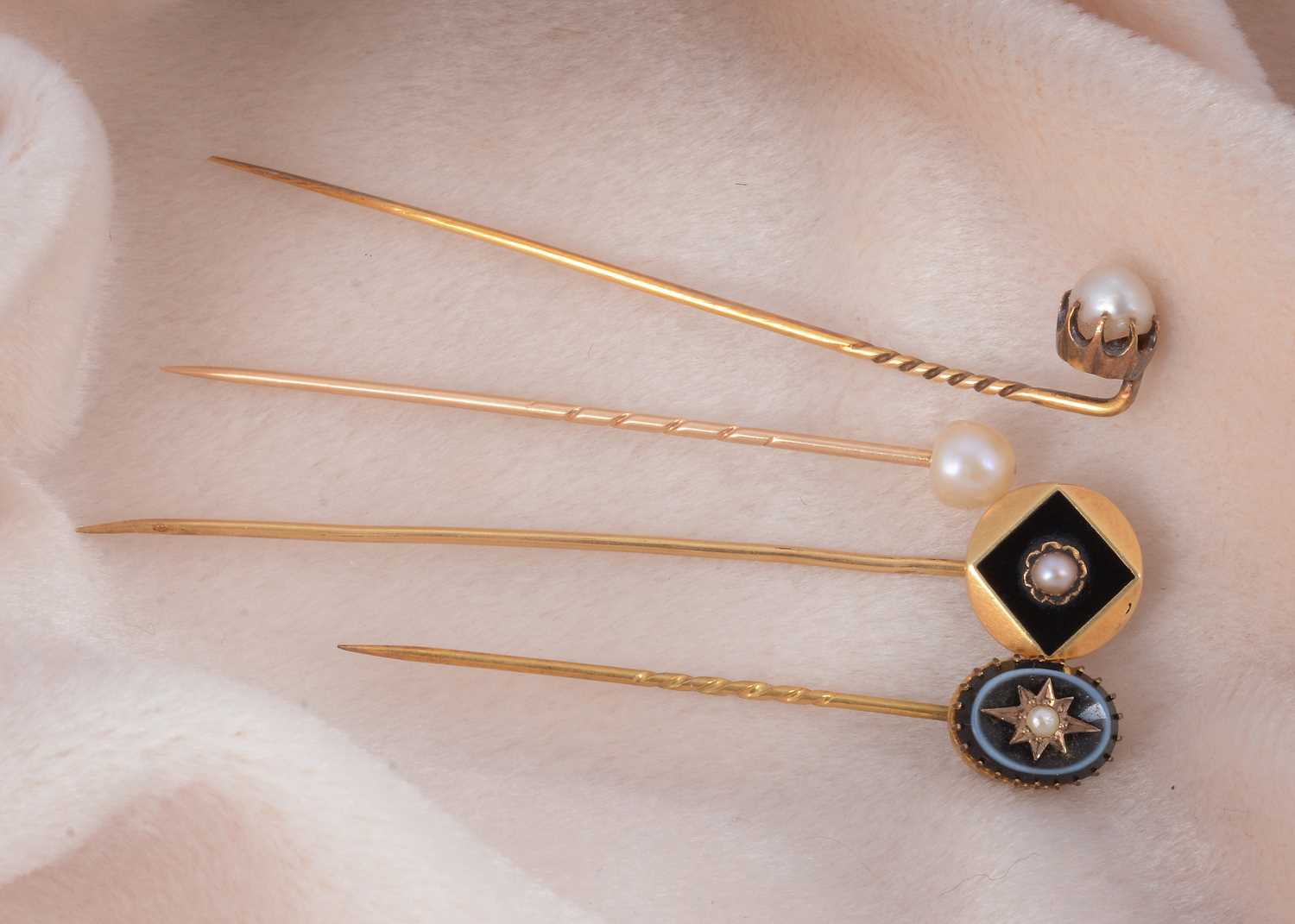 Lot 13 - Four pearl set stick pins