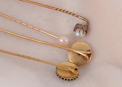 Lot 13 - Four pearl set stick pins