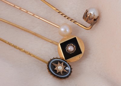 Lot 13 - Four pearl set stick pins
