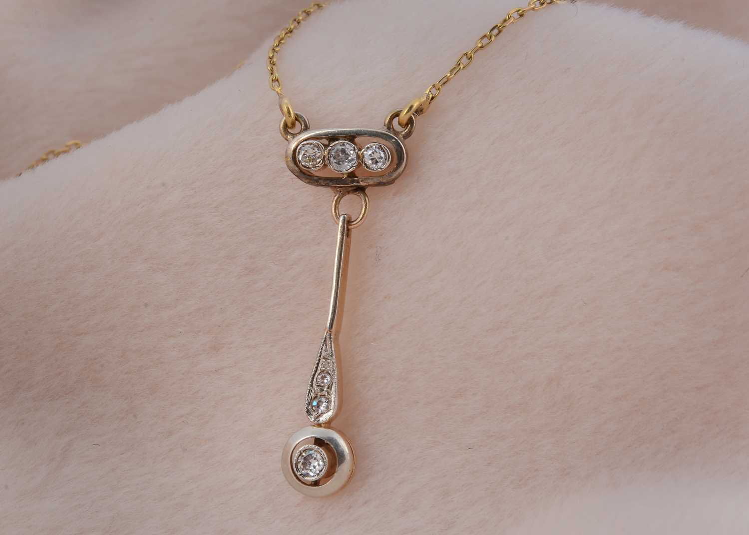 Lot 14 - An Edwardian fine diamond drop pendant and chain