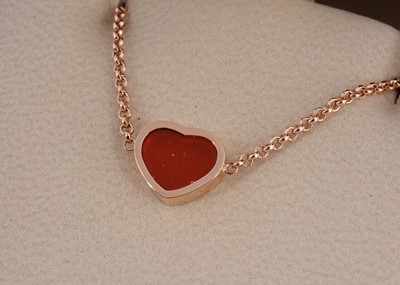 Lot 18 - A Chopard 18ct gold and carnelian heart shaped bracelet
