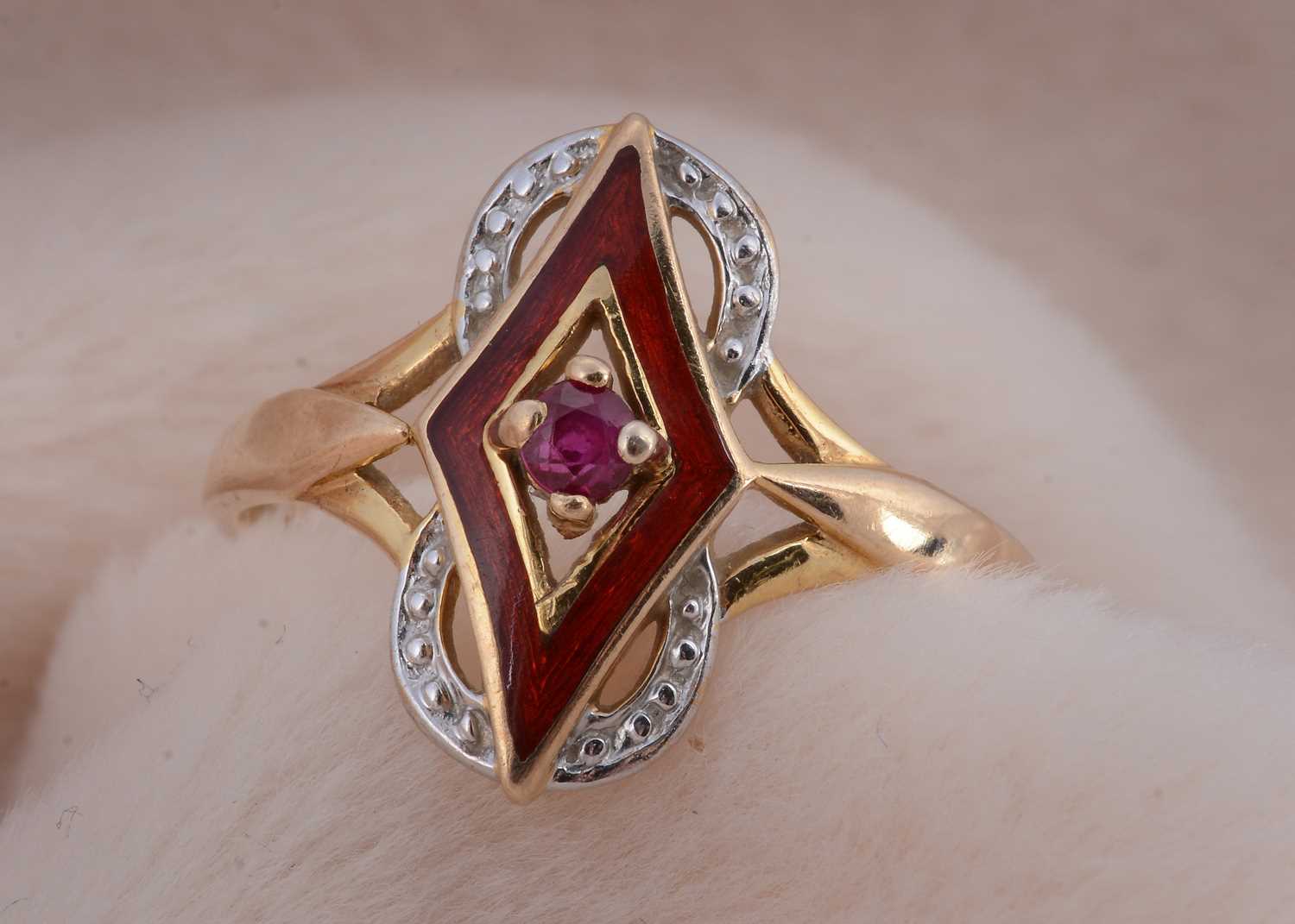 Lot 27 - A 9ct gold ruby enamel and two colour gold dress ring
