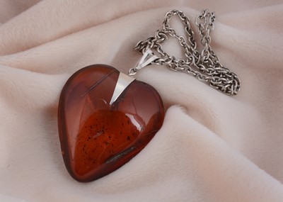 Lot 33 - A polished continental amber heart pendant