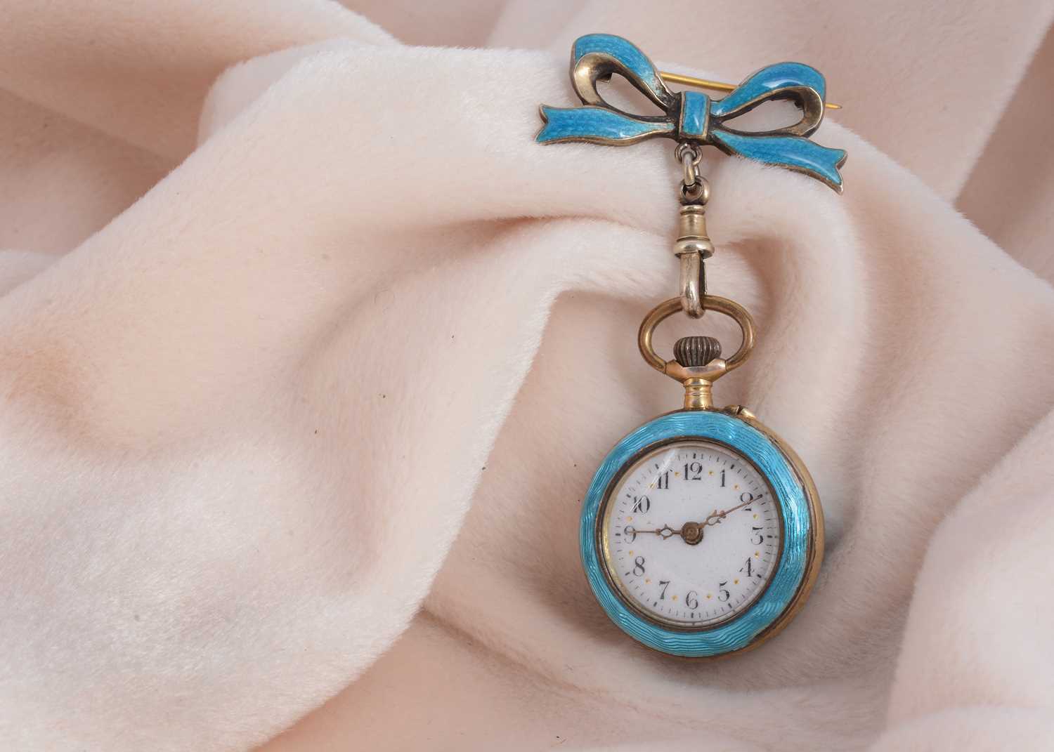 Lot 47 - A continental silver gilt and enamel lady's fob watch and matching bow brooch