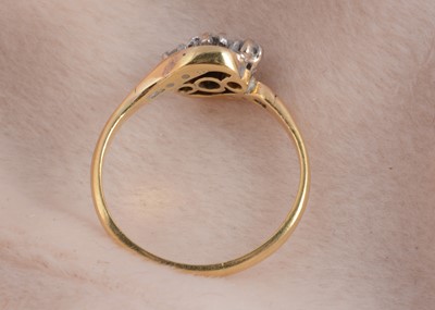 Lot 50 - An 18ct gold and platinum three stone crossover dress ring