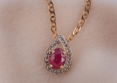 Lot 73 - A 14ct gold ruby and diamond oval drop pendant