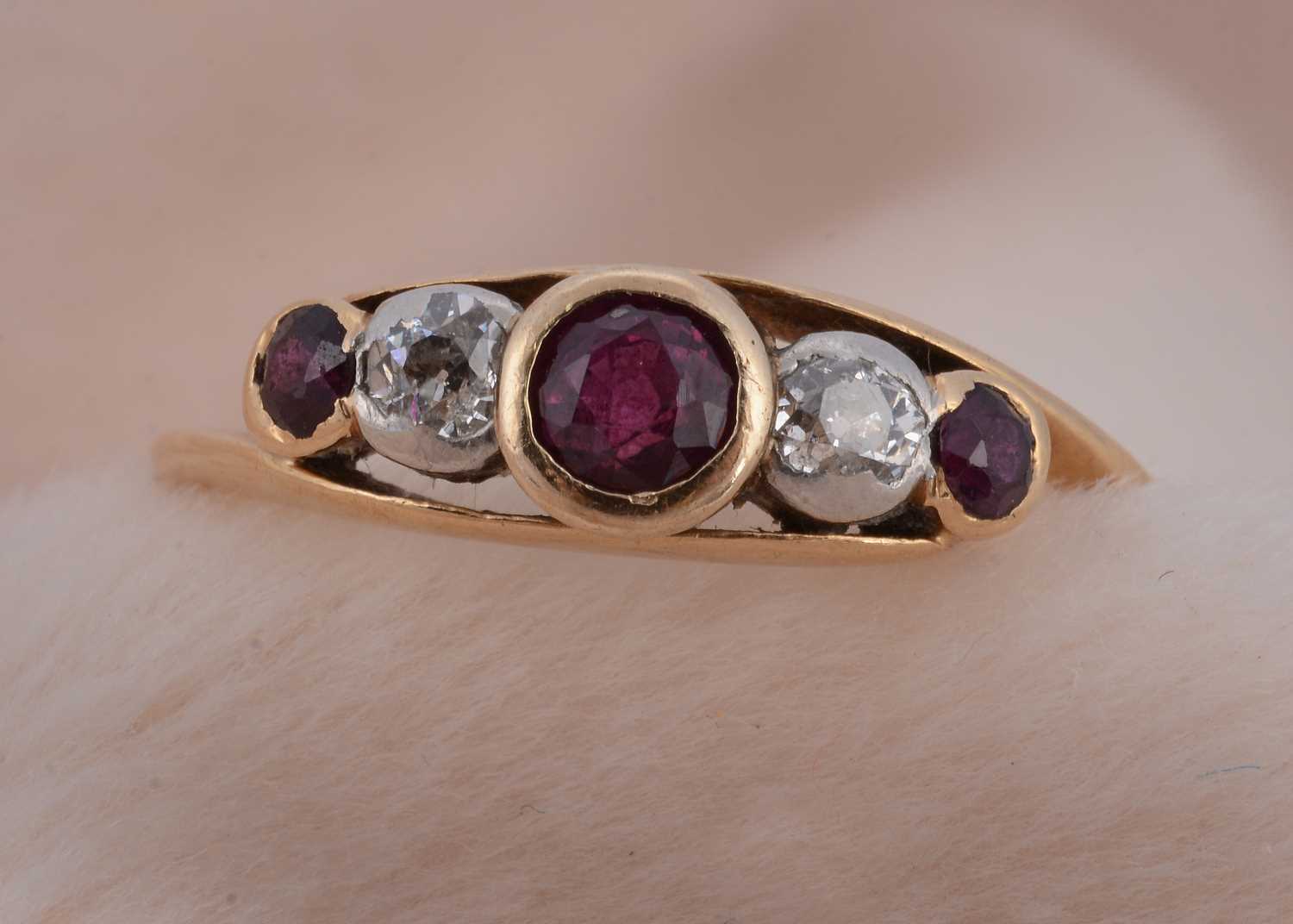 Lot 74 - An 18ct gold platinum, ruby and diamond set five stone dress ring