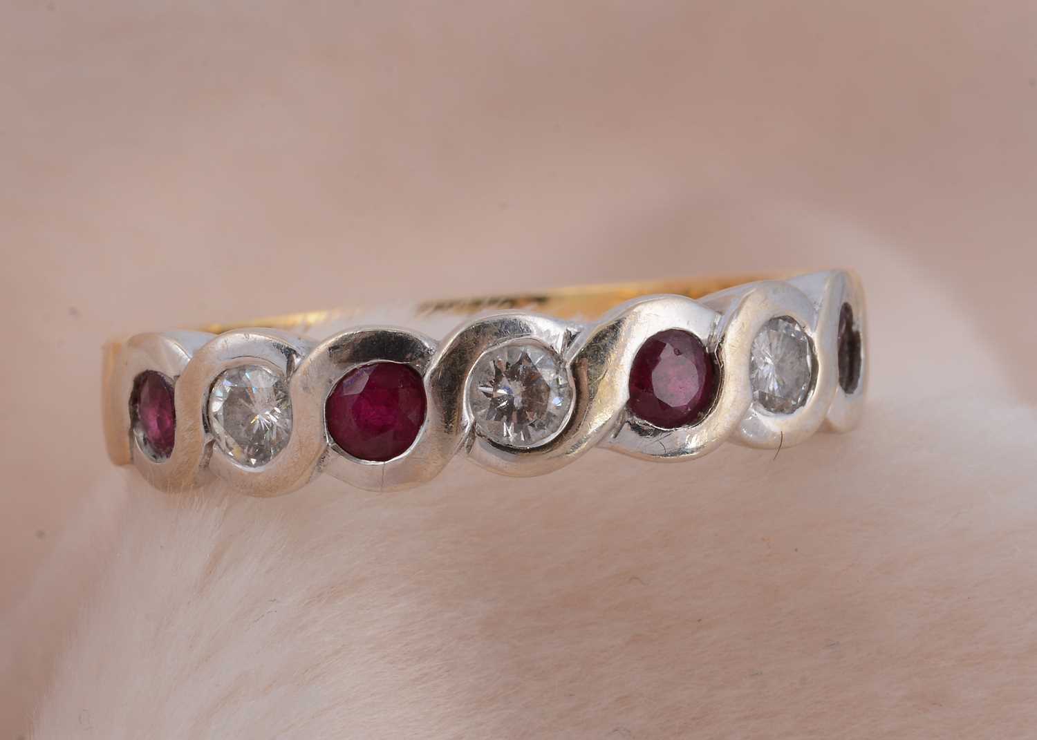 Lot 75 - A seven stone ruby and diamond 18ct gold dress ring