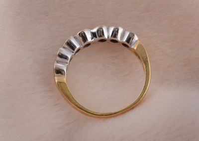 Lot 75 - A seven stone ruby and diamond 18ct gold dress ring