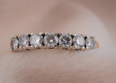 Lot 76 - An 18ct gold seven stone diamond dress ring