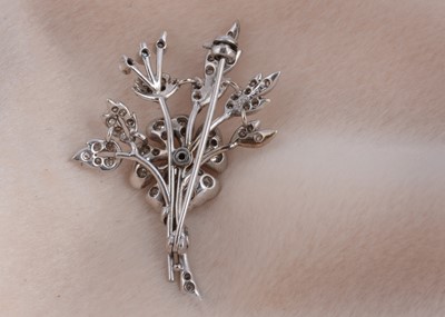 Lot 77 - A 9ct white gold floral diamond set spray brooch