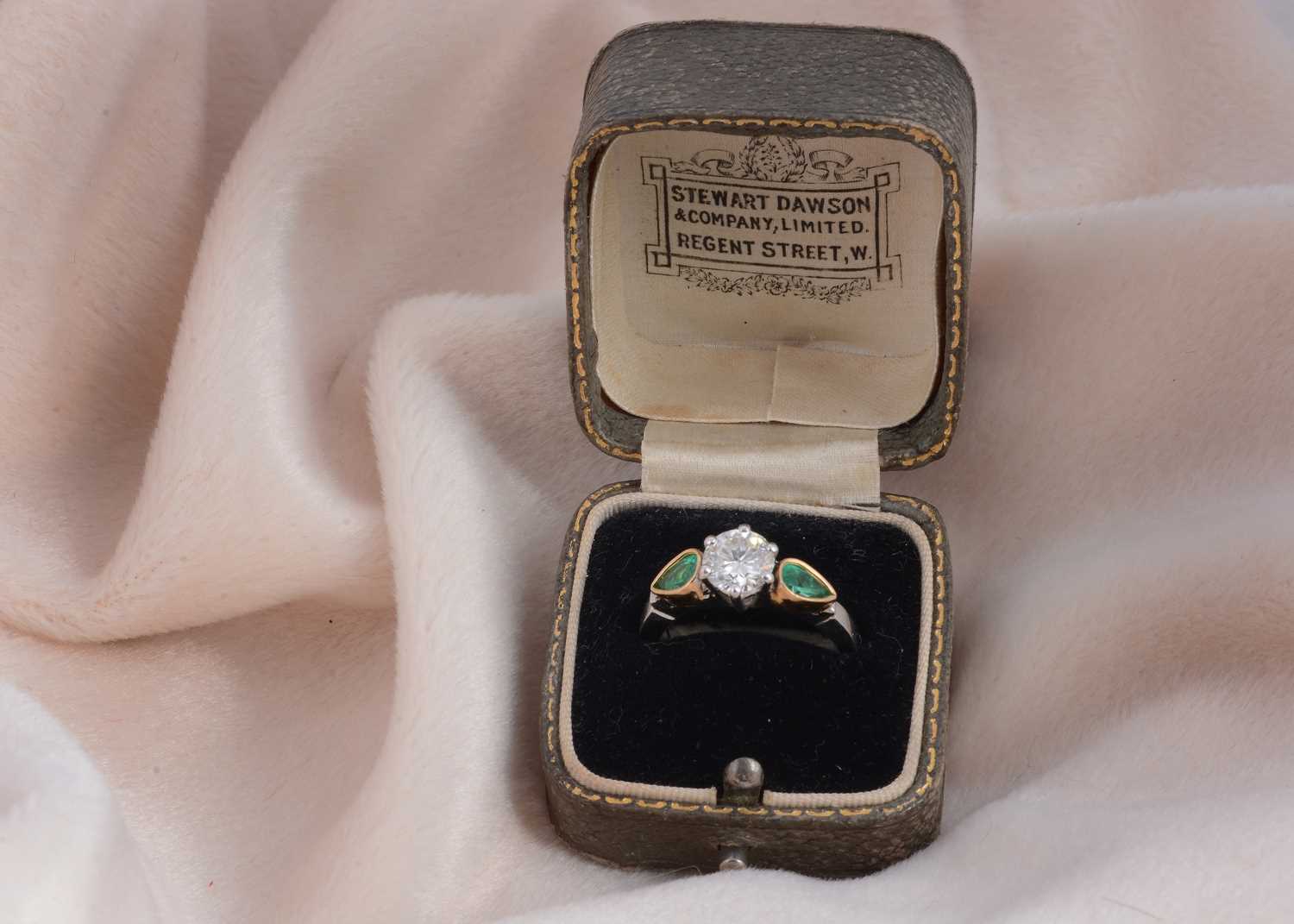 Lot 80 - A three stone emerald and diamond 18ct gold dress ring