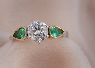 Lot 80 - A three stone emerald and diamond 18ct gold dress ring