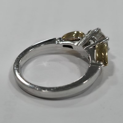 Lot 80 - A three stone emerald and diamond 18ct gold dress ring