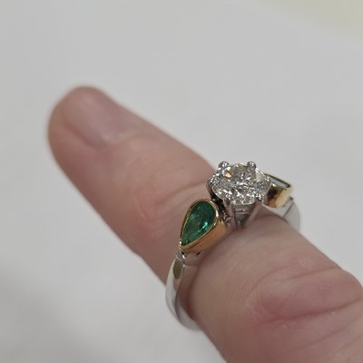 Lot 80 - A three stone emerald and diamond 18ct gold dress ring