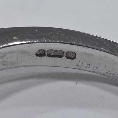 Lot 80 - A three stone emerald and diamond 18ct gold dress ring