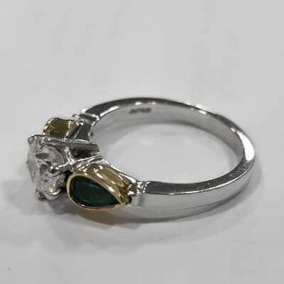 Lot 80 - A three stone emerald and diamond 18ct gold dress ring