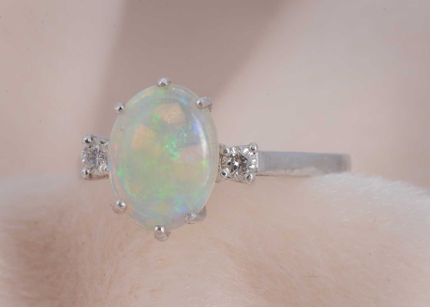 Lot 81 - An 18ct gold opal and diamond three stone dress ring