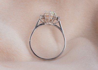 Lot 81 - An 18ct gold opal and diamond three stone dress ring