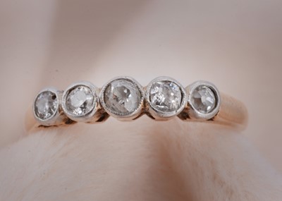 Lot 83 - A five stone diamond 18ct gold and platinum dress ring
