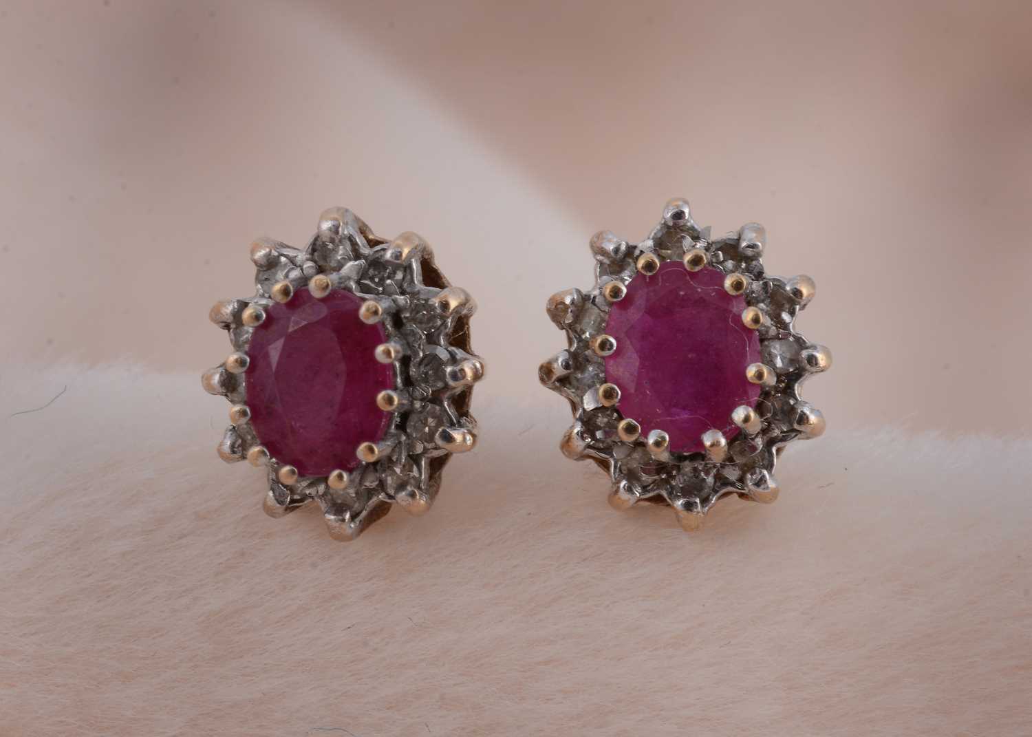 Lot 90 - A pair of 9ct gold ruby and diamond cluster stud earrings