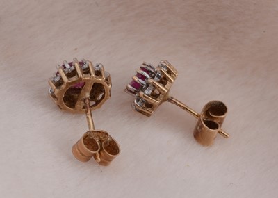 Lot 90 - A pair of 9ct gold ruby and diamond cluster stud earrings