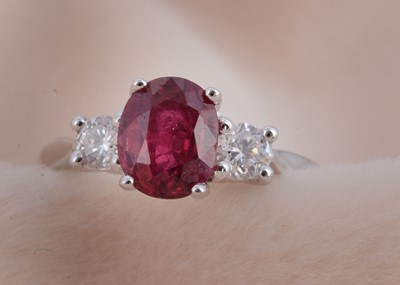 Lot 91 - An 18ct white gold ruby and diamond three stone dress ring