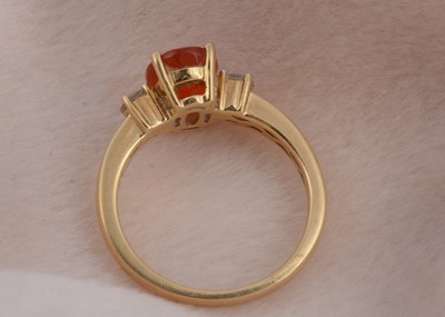 Lot 92 - An 18ct gold fire opal and diamond three stone dress ring