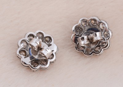 Lot 93 - A pair of 18ct white gold sapphire and diamond cluster ear studs