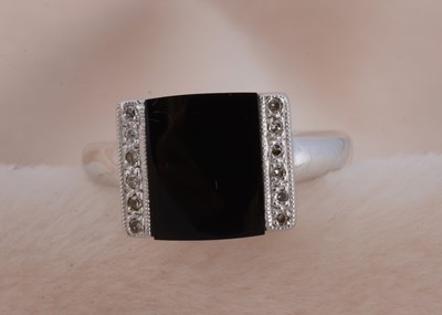 Lot 96 - A 9ct gold onyx and diamond dress ring