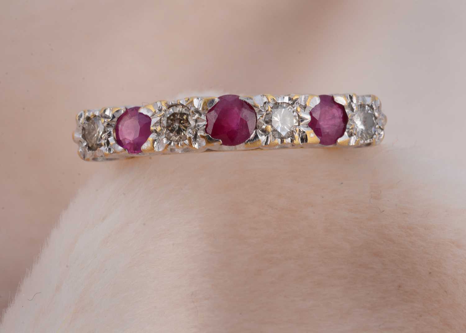 Lot 100 - A ruby and diamond 18ct gold seven stone dress ring