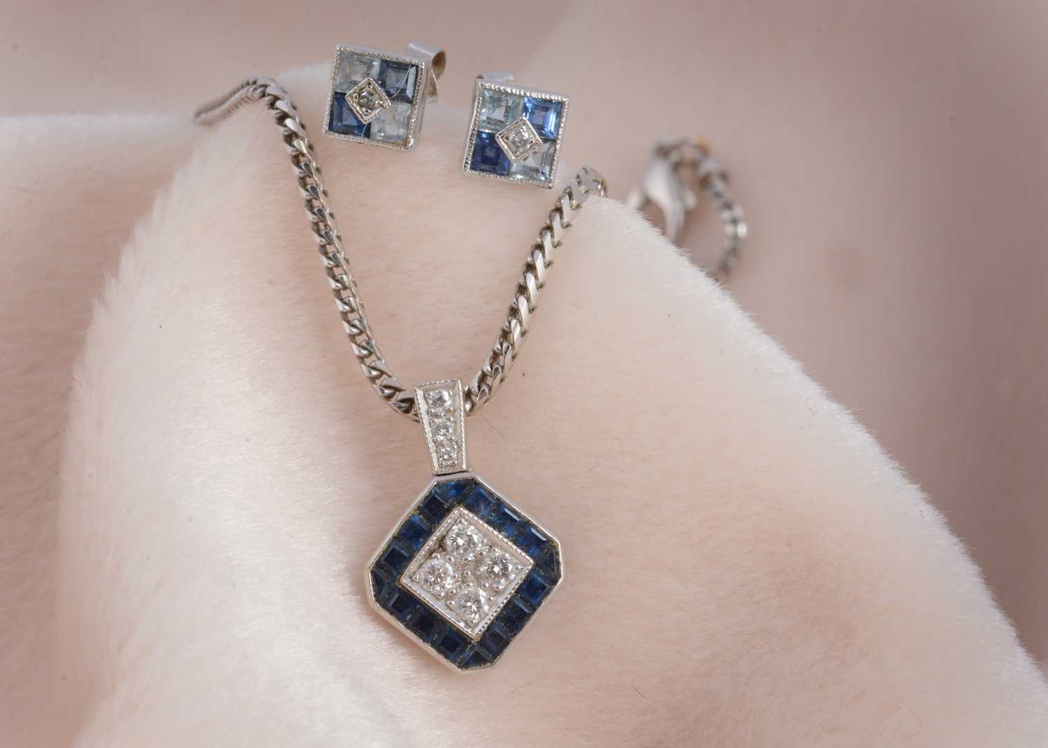 Lot 105 - An 18ct gold sapphire and diamond lozenge shaped pendant