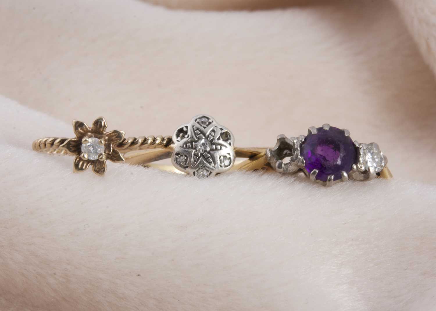 Lot 130 - An 18ct gold and platinum set three stone amethyst and diamond dress ring