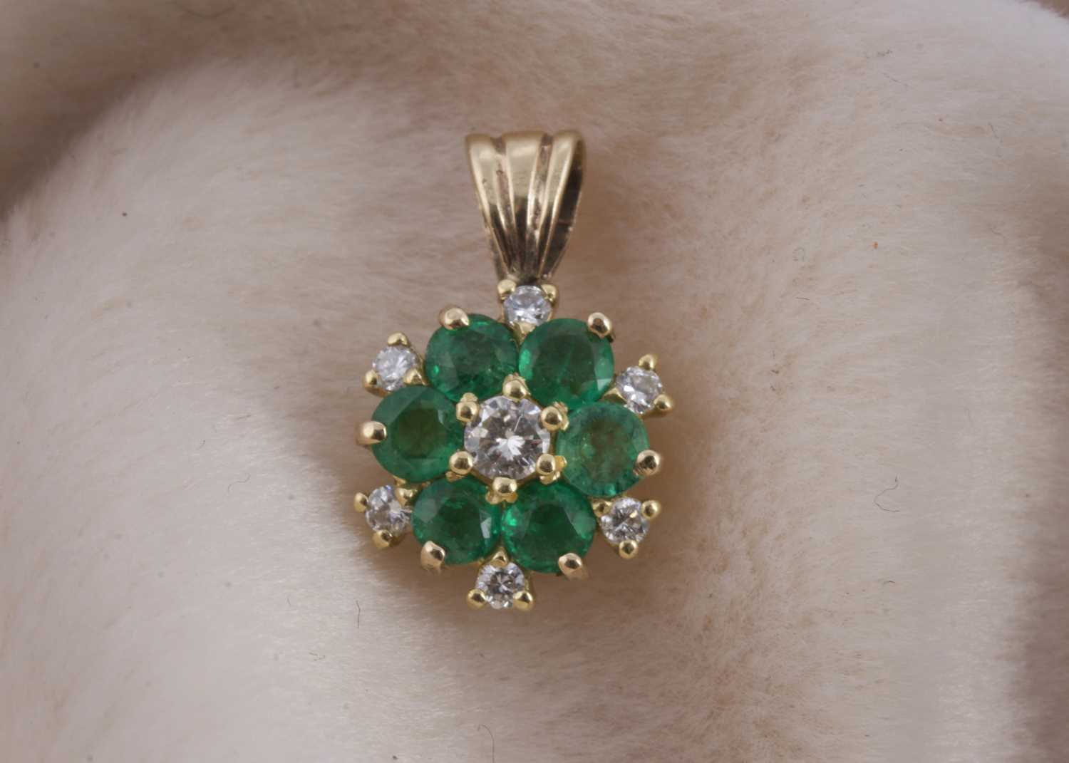 Lot 141 - An 18ct gold emerald and diamond cluster pendant
